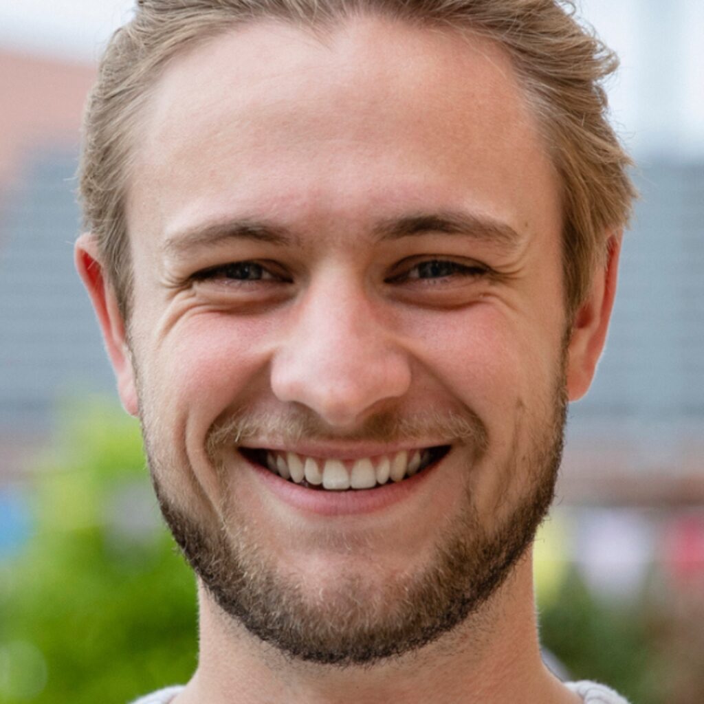 younger man smiling at camera