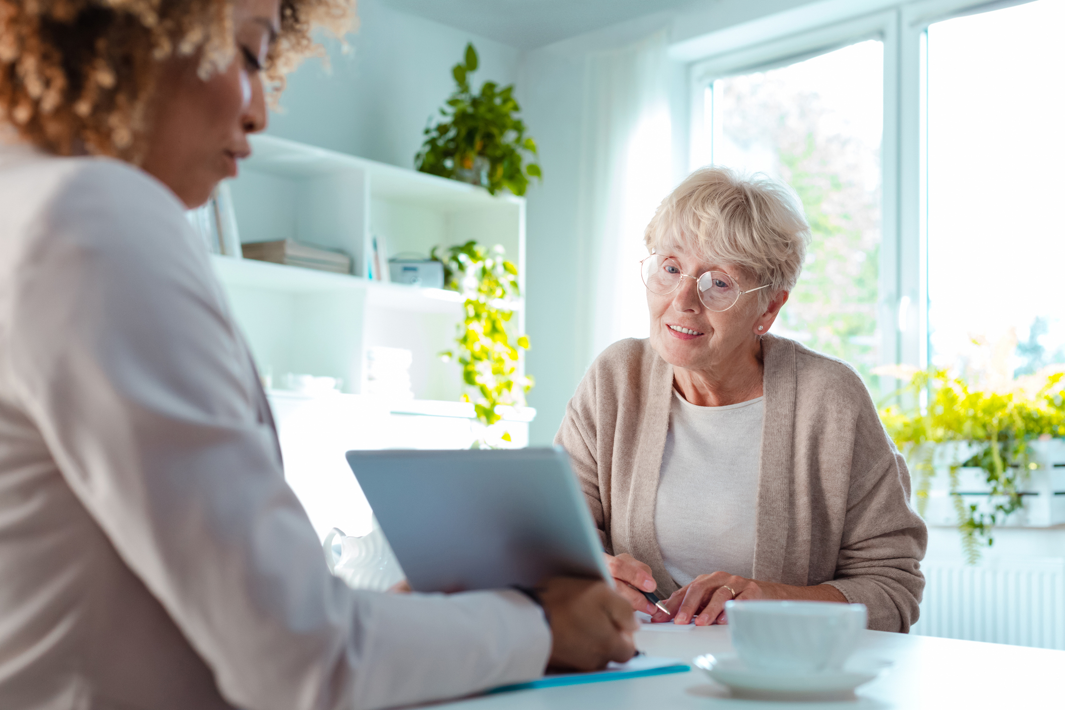 Senior woman talking with professional