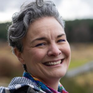 woman outdoors laughing at the camera