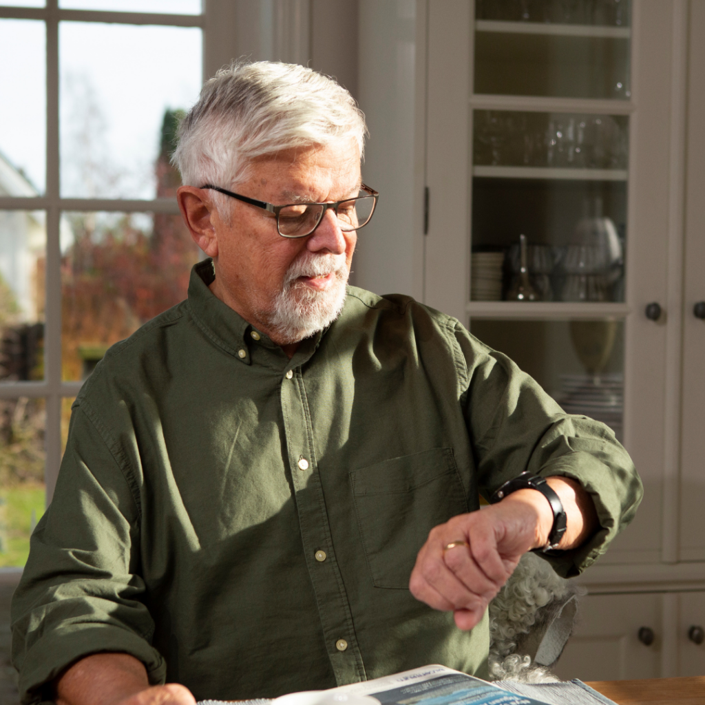 Older man looking at a GPS watch