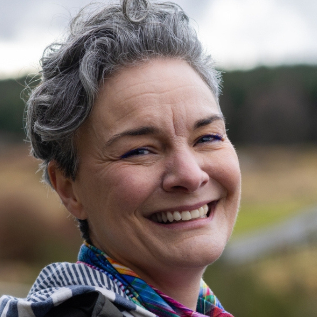 woman outdoors laughing at the camera