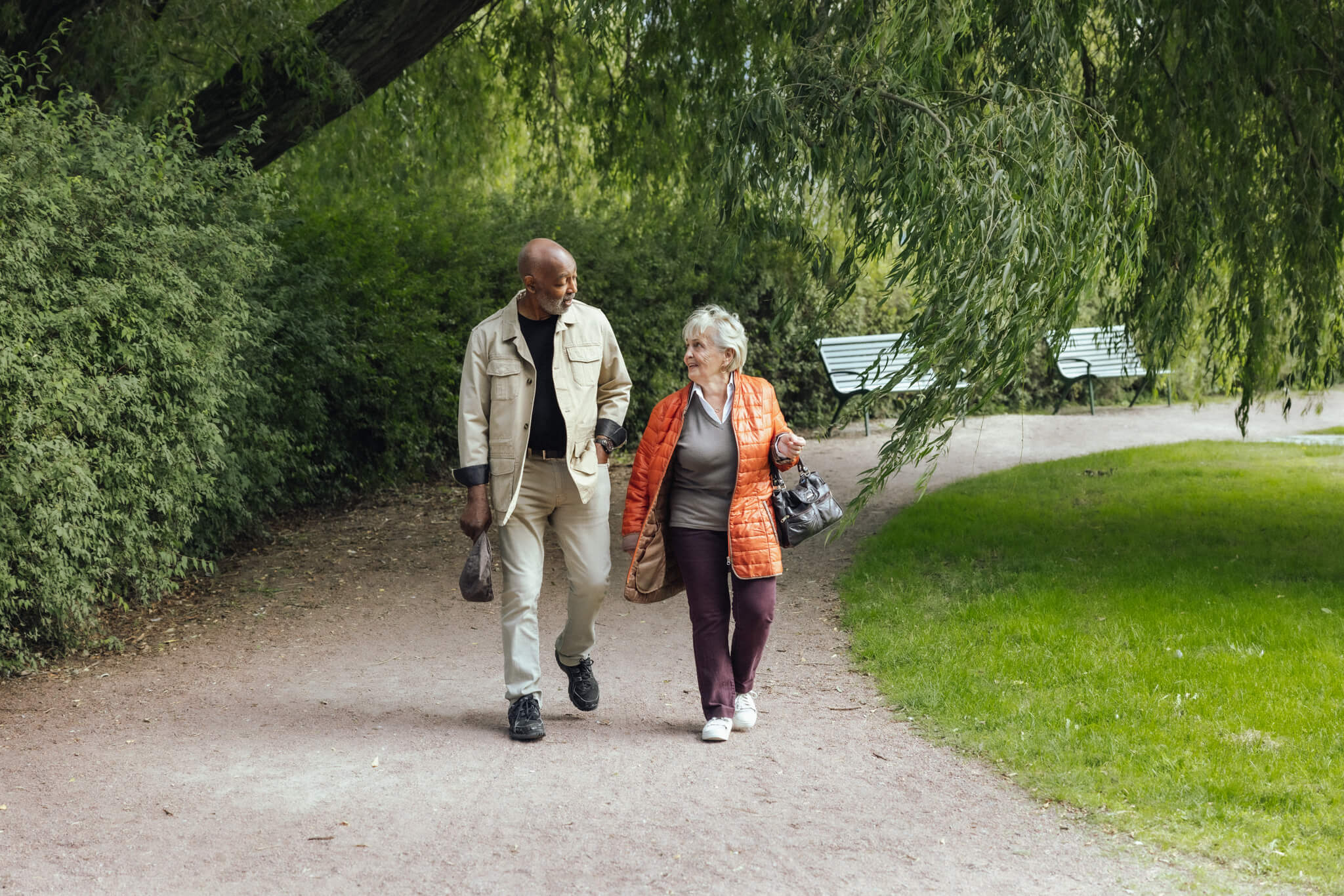 Senior man and woman walking in park