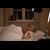 Senior woman sleeping in bed with Doro Visit camera in background