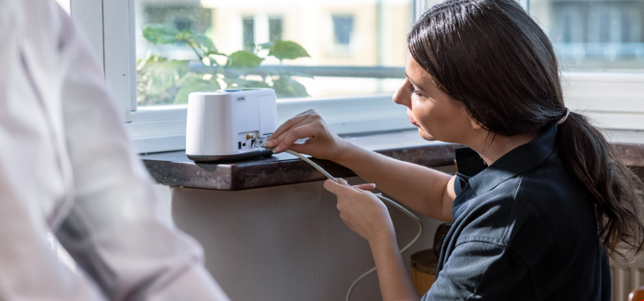 Carer installing social alarm Eliza