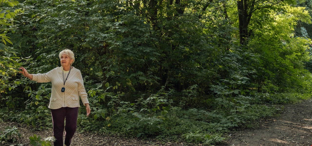 Elderly woman walking in the wood