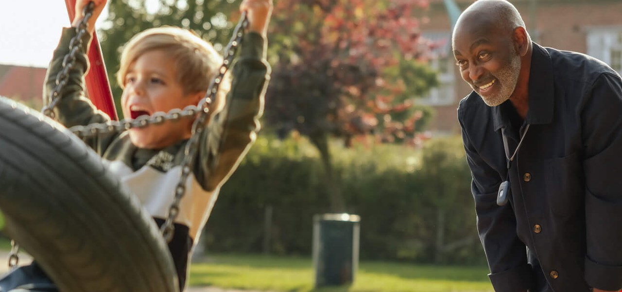 Man and boy playing in park.