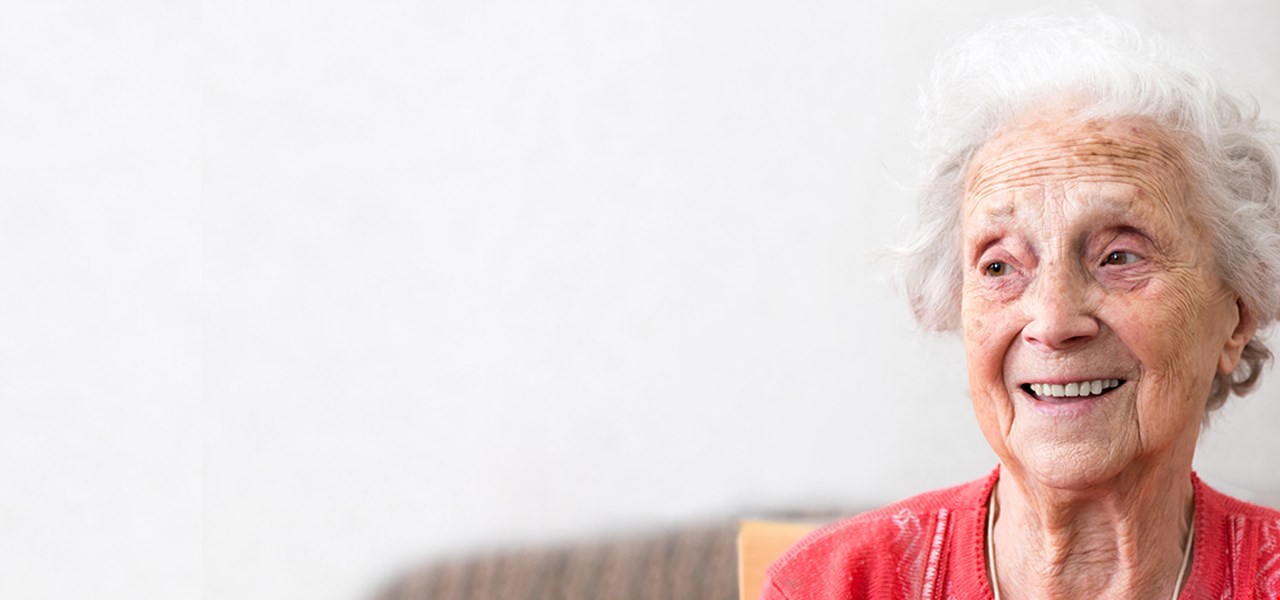 Senior woman in red jumper smiling